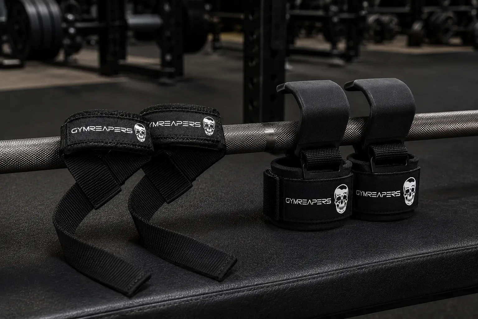 Lifting straps and lifting hooks compared side by side on a barbell in a strength gym